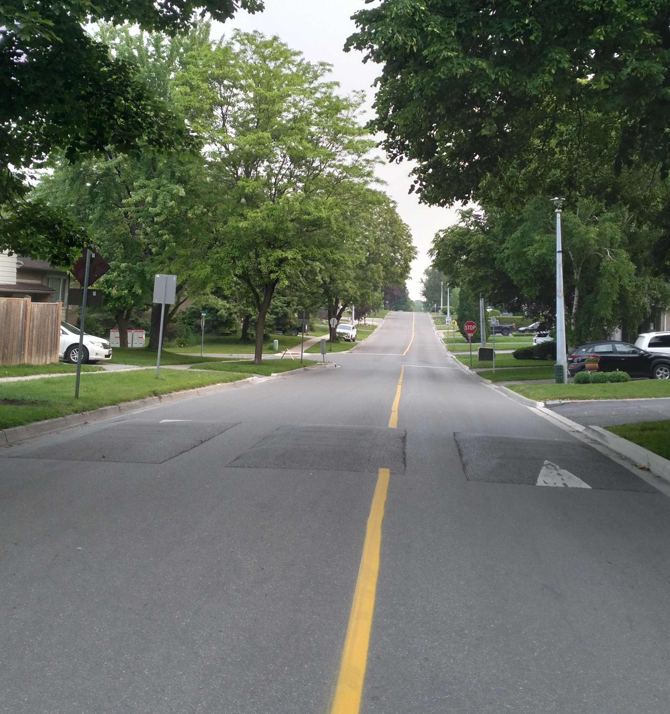 This street's yellow line is off-centre, creating one lane which is 
        rather narrow and one which is rather wide, allowing for street parking on that side.