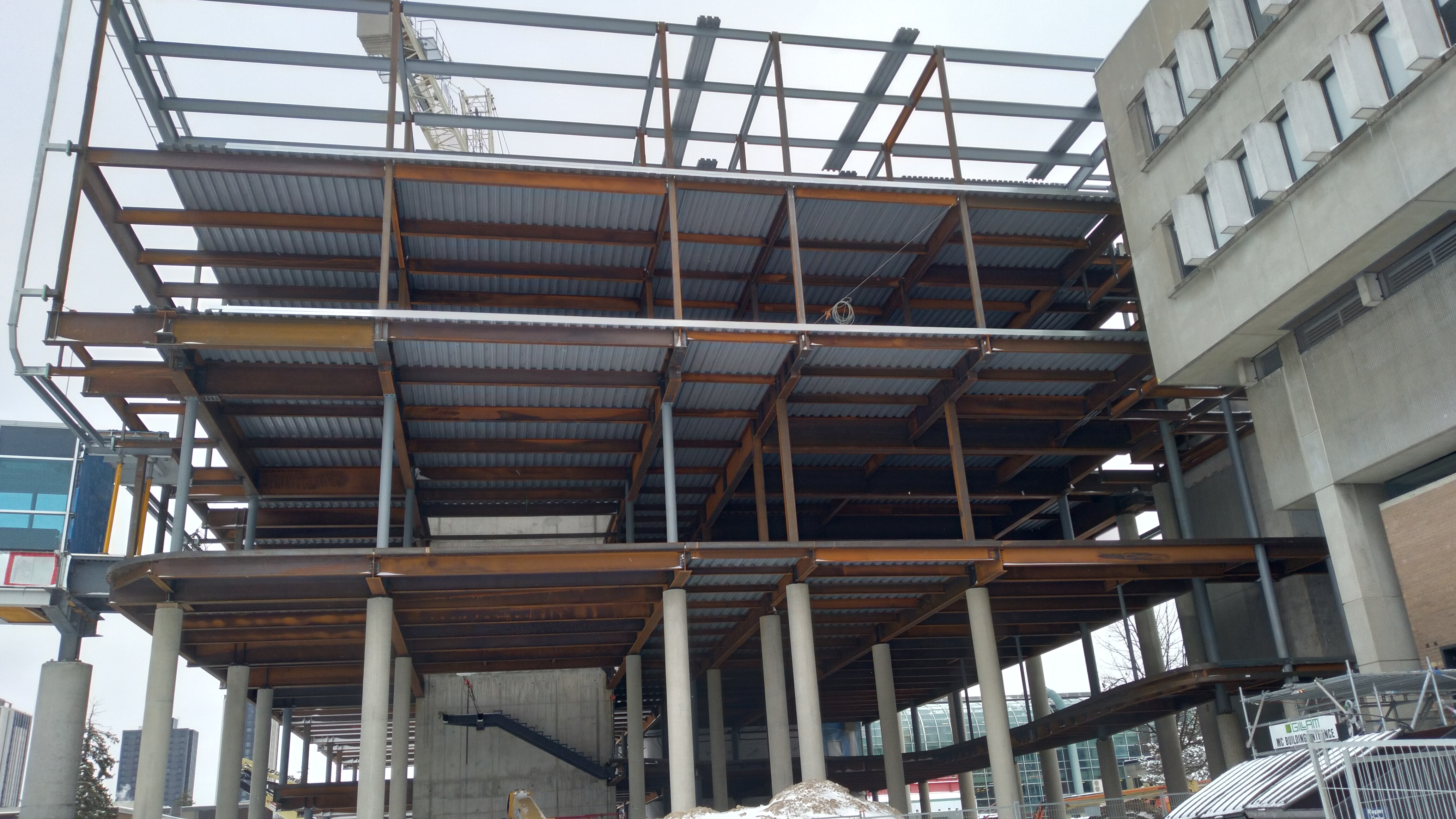 Ruffled steel plates covering most floors on the west side of the building, November 2025.
